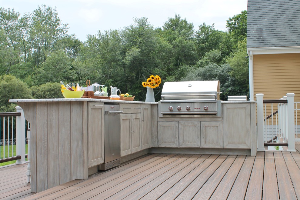 Photo of a large bohemian back patio in Boston with an outdoor kitchen, decking and no cover.