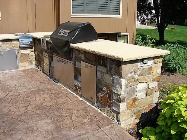 Patio kitchen - mid-sized traditional backyard stone patio kitchen idea in Kansas City with no cover