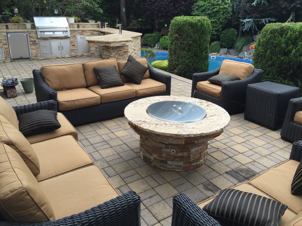 Patio - large transitional backyard brick patio idea in New York with a fire pit and no cover