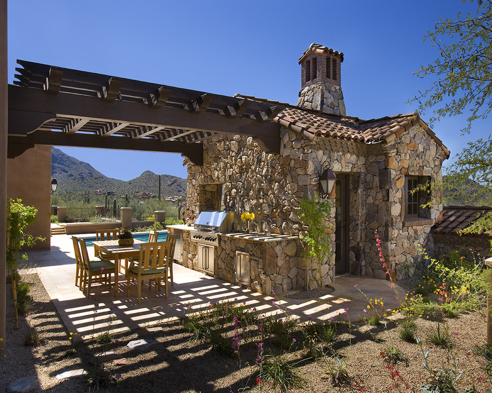 This is an example of a traditional patio in Phoenix with a pergola and a bbq area.