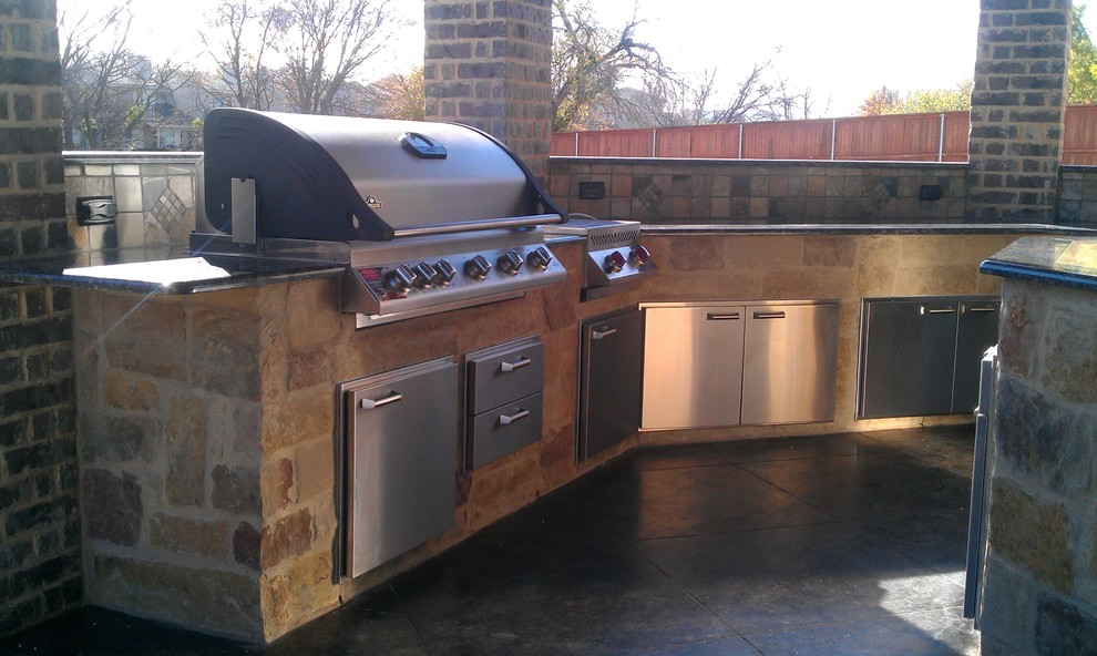 Large traditional back patio in Dallas with an outdoor kitchen, concrete slabs and a roof extension.