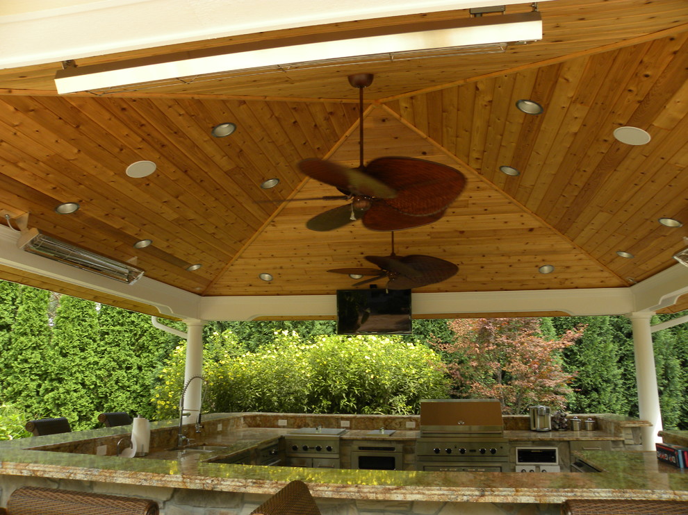 Patio kitchen - huge traditional backyard patio kitchen idea in Chicago with a gazebo