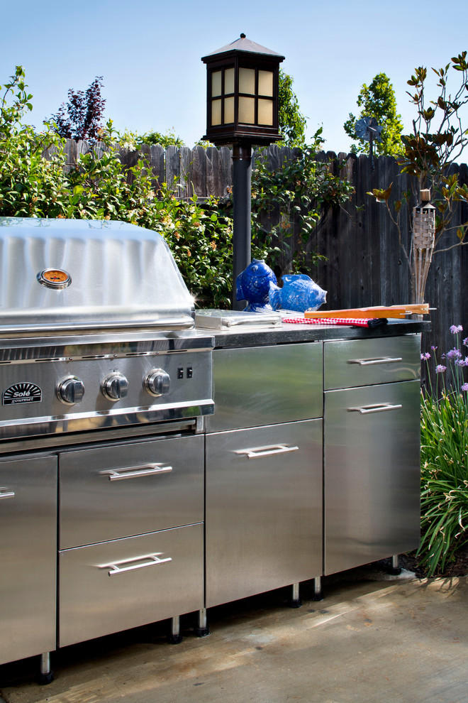 На фото: пергола во дворе частного дома на заднем дворе в современном стиле с летней кухней и покрытием из бетонных плит с