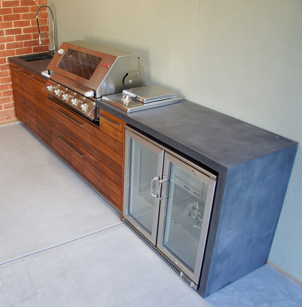 Outdoor kitchen with a polished concrete benchtop & hardwood doors