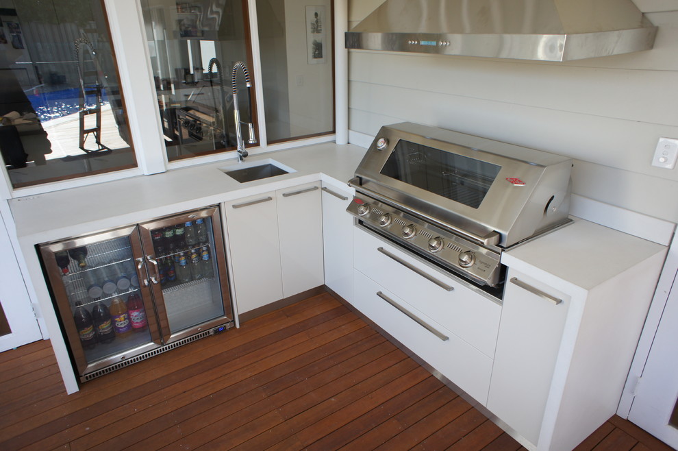 Outdoor kitchen with a white polished concrete benchtop. Contemporary