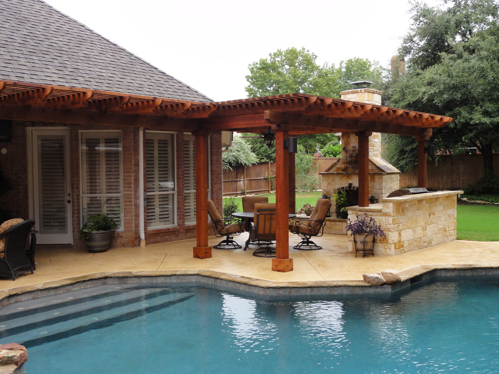 Design ideas for a medium sized traditional back patio in Dallas with an outdoor kitchen and a pergola.