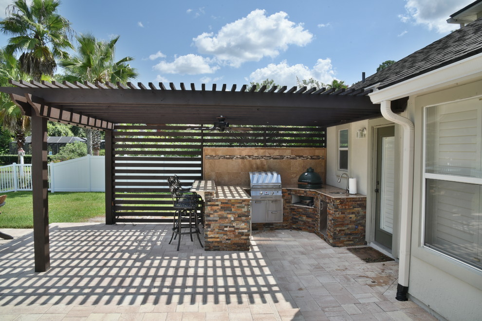 Ejemplo de patio contemporáneo de tamaño medio en patio trasero con cocina exterior, adoquines de hormigón y pérgola