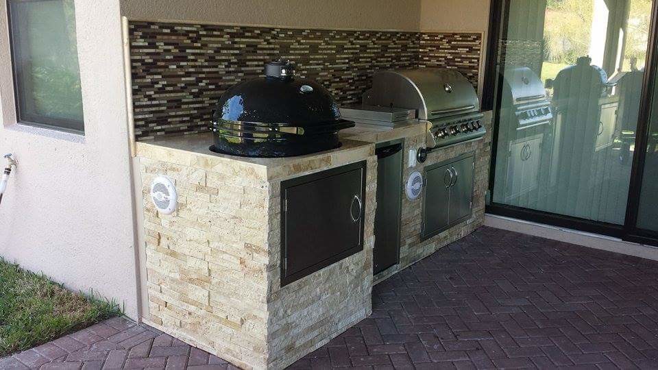 Small tuscan backyard patio kitchen photo in Jacksonville with a roof extension