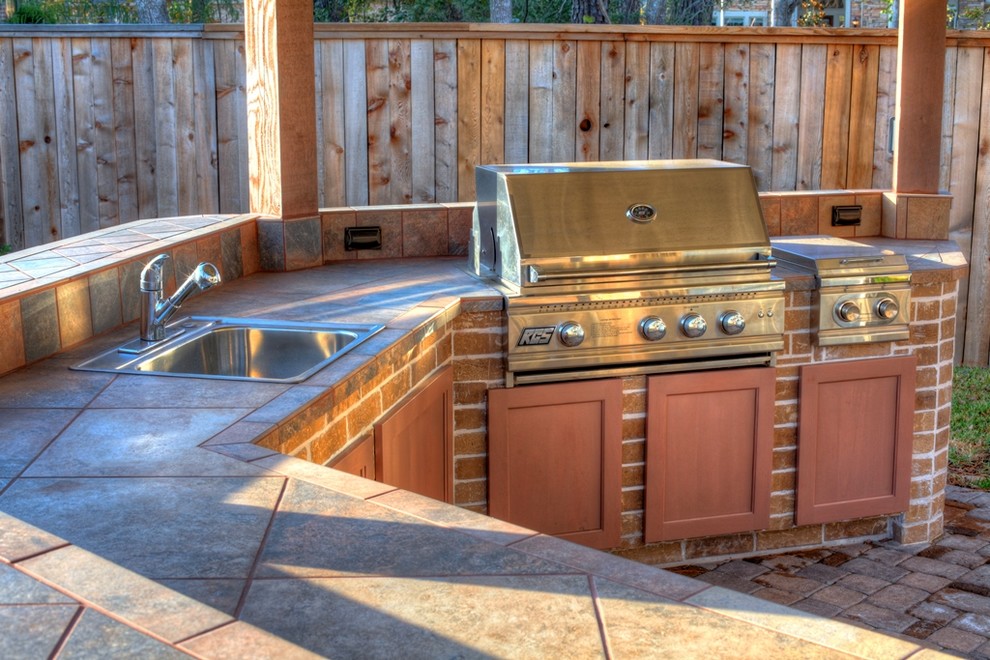 Outdoor Kitchen with stone pavers Transitional Patio Houston by