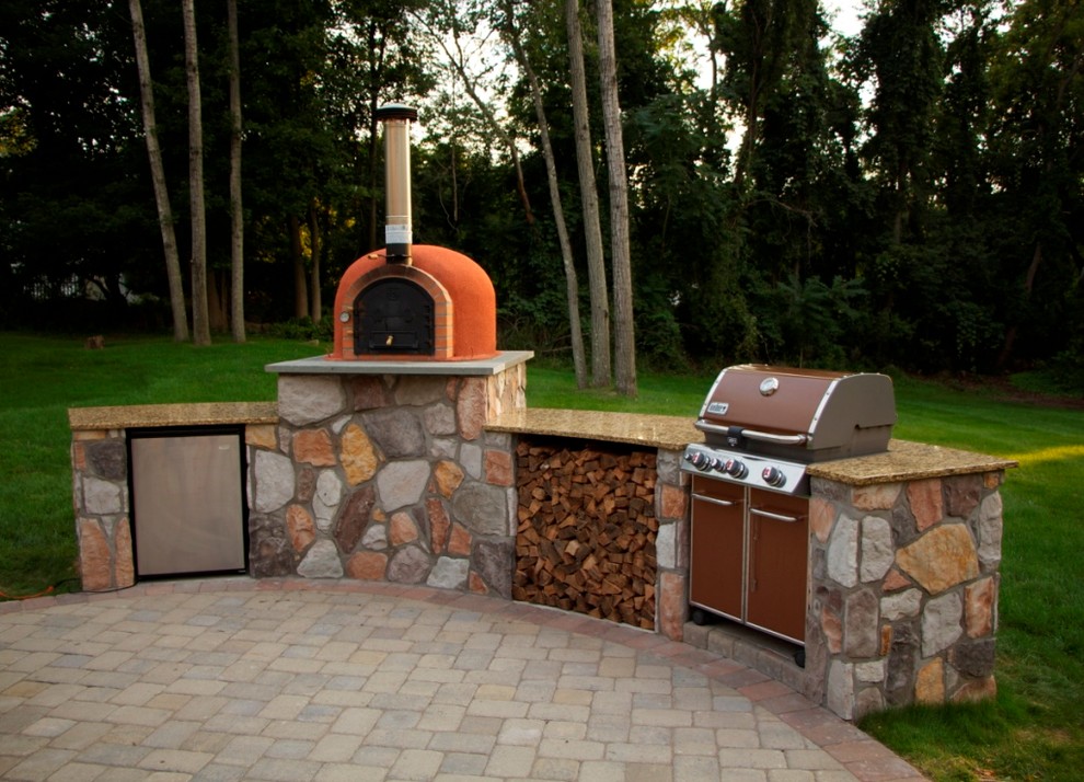 Inspiration for a mid-sized timeless backyard brick patio kitchen remodel in New York with a roof extension