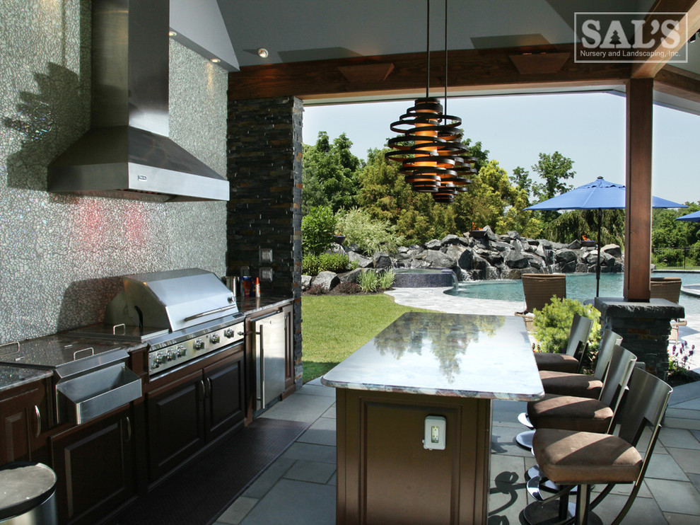 Patio kitchen - mid-sized traditional backyard stone patio kitchen idea in Philadelphia with a roof extension