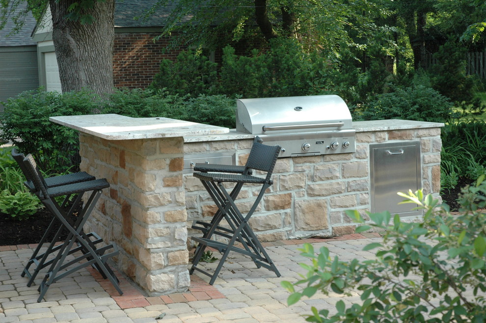 Foto de patio tradicional sin cubierta en patio trasero con cocina exterior y adoquines de hormigón