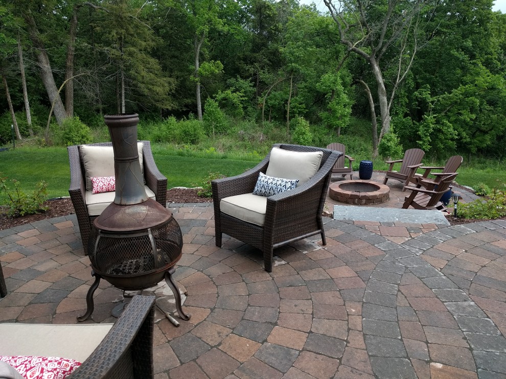 Medium sized traditional back patio in Minneapolis with a fire feature, concrete paving and no cover.