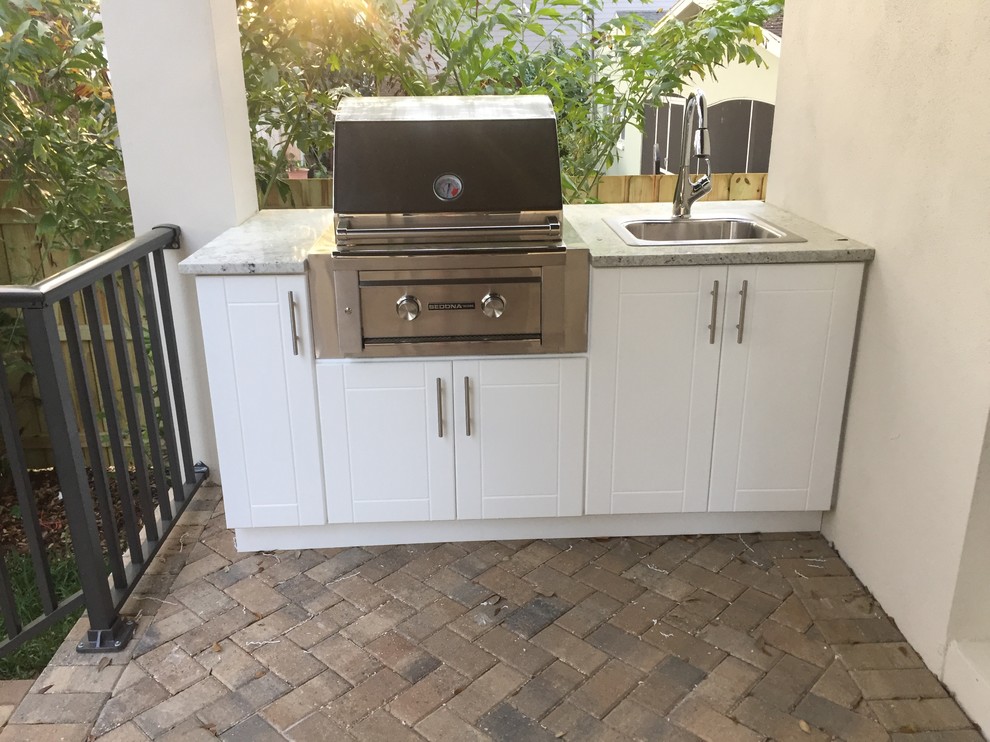 Large trendy backyard patio kitchen photo in Tampa with a roof extension