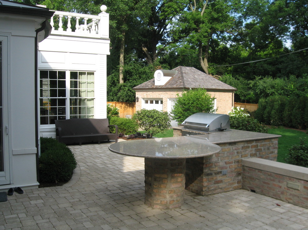 Foto di un patio o portico chic in cortile con pavimentazioni in mattoni