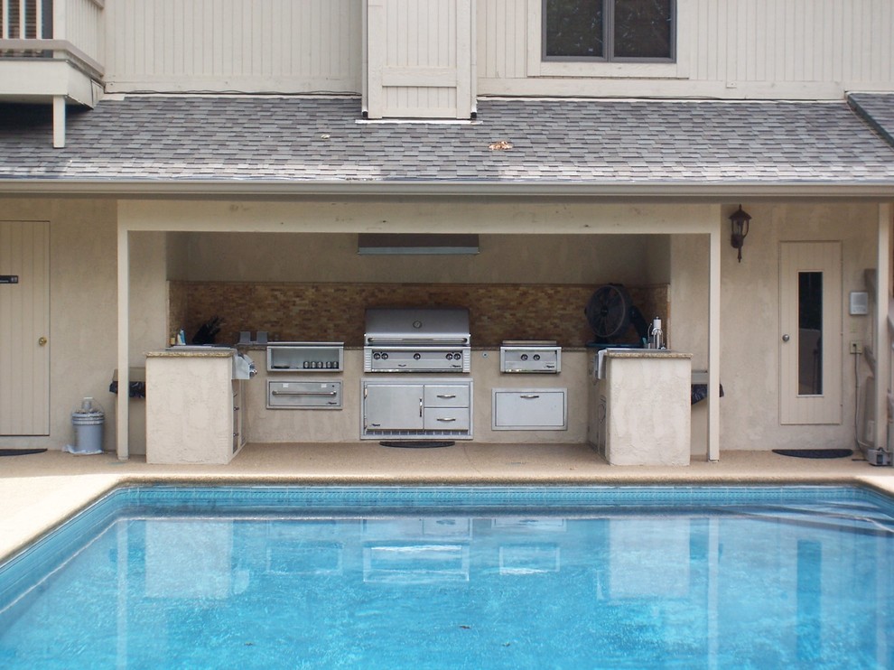 Example of a small transitional backyard patio kitchen design in Other with a roof extension