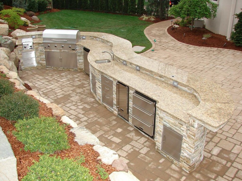 Design ideas for a large contemporary back patio in Houston with an outdoor kitchen, concrete paving and no cover.