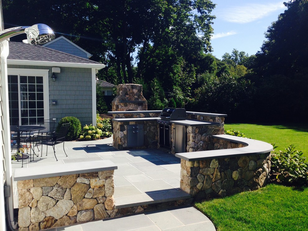 Inspiration for a large traditional back patio in New York with an outdoor kitchen, concrete paving and no cover.