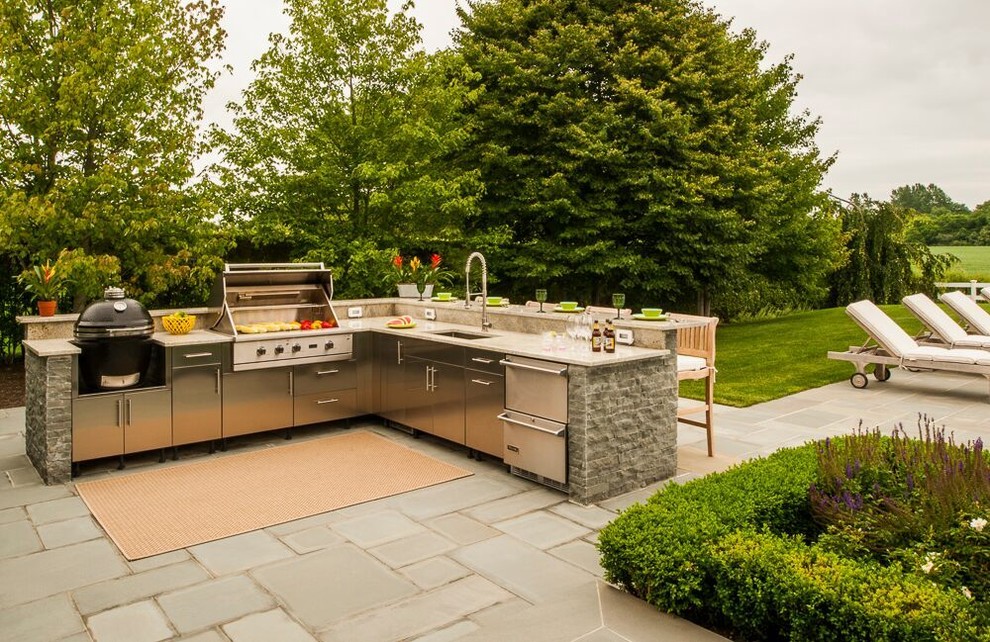 Inspiration for a large traditional back patio in New York with an outdoor kitchen, an awning and concrete paving.