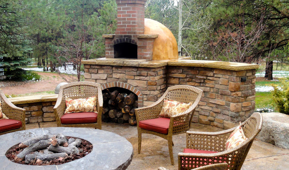 Elegant backyard patio photo in Denver with a fire pit and no cover
