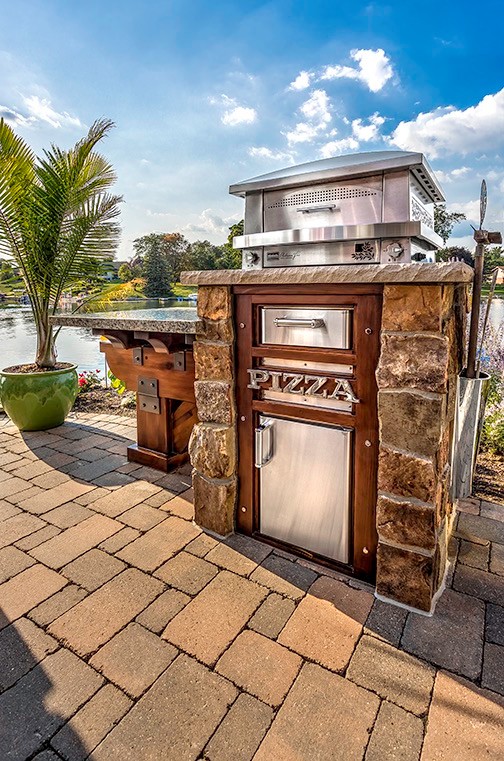 Mid-sized elegant backyard concrete paver patio kitchen photo in Detroit