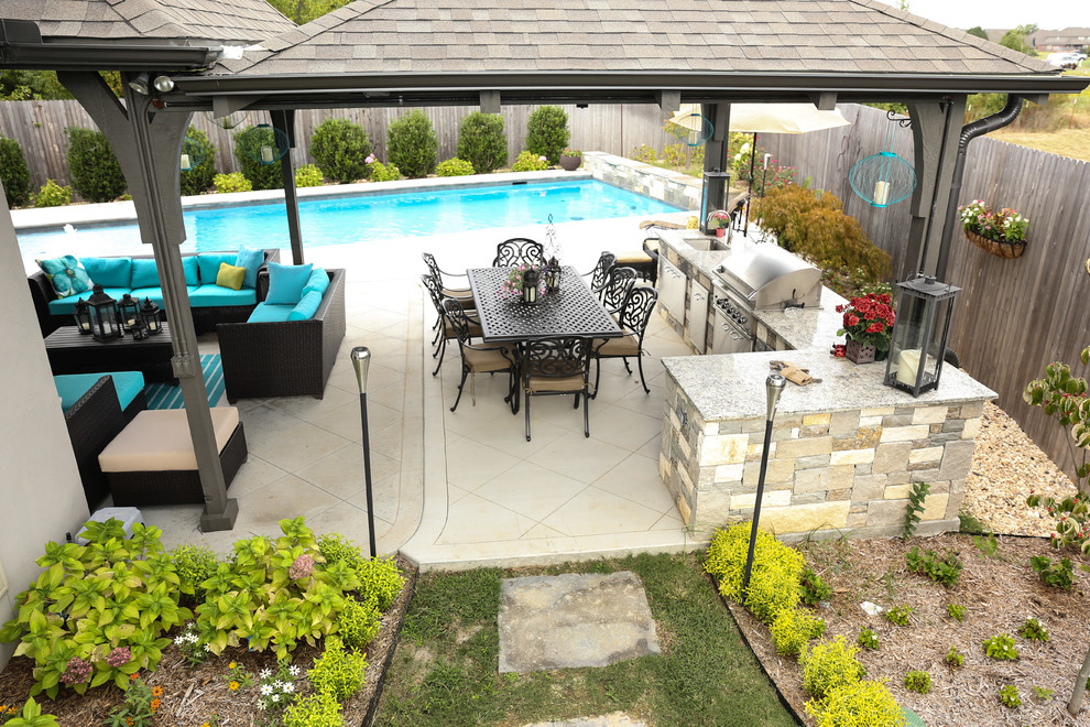 Inspiration for a large contemporary backyard concrete patio kitchen remodel in Other with a pergola