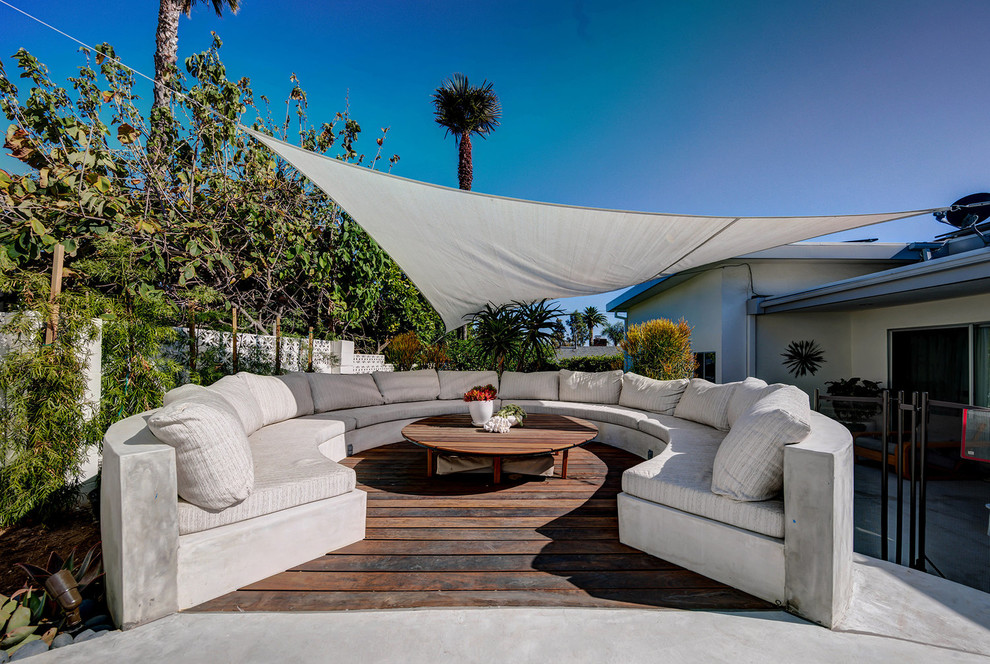 This is an example of a large classic back patio in Los Angeles with an awning.