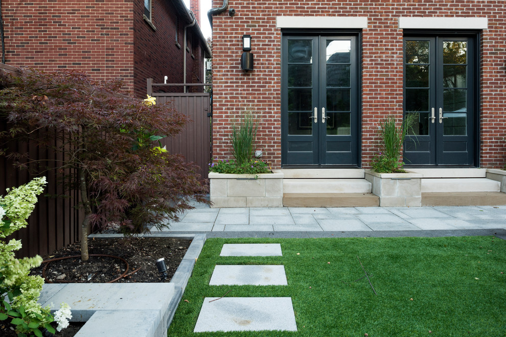 Patio - mid-sized contemporary backyard concrete paver patio idea in Toronto with no cover