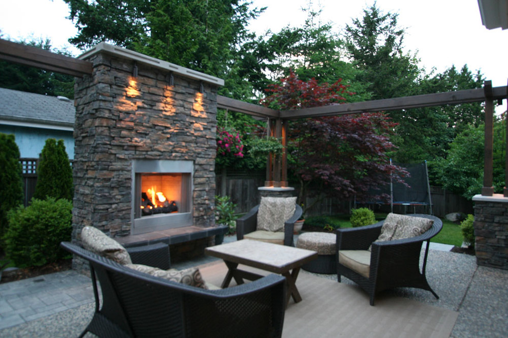 Patio - large contemporary backyard concrete patio idea in Vancouver with a fire pit and no cover