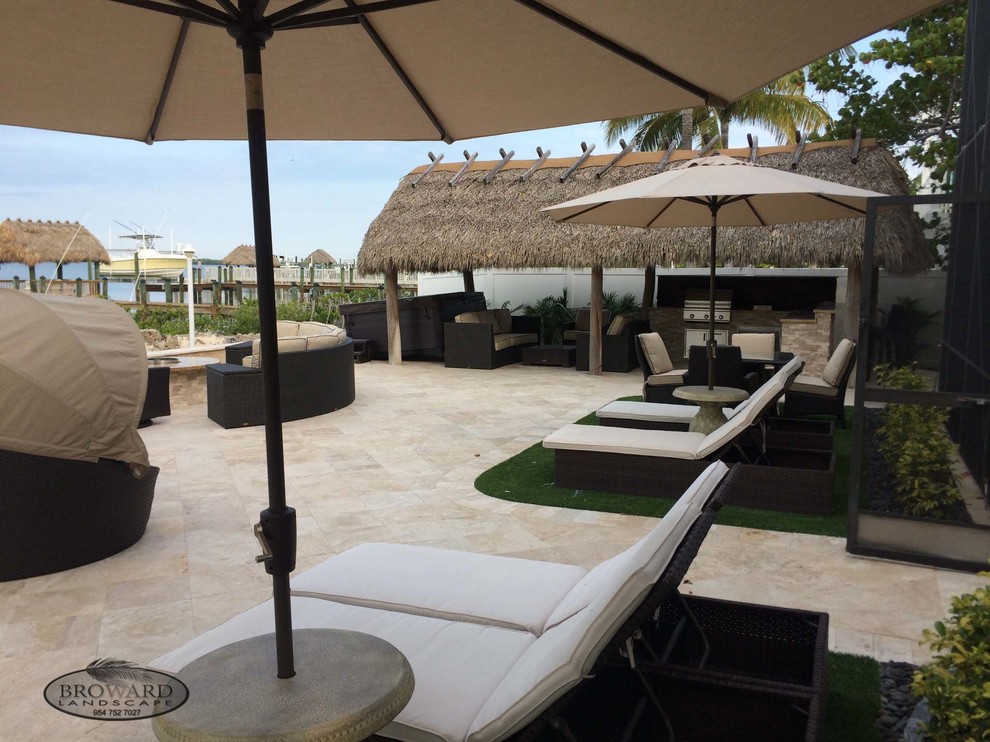 Inspiration for a medium sized nautical back patio in Miami with natural stone paving and no cover.