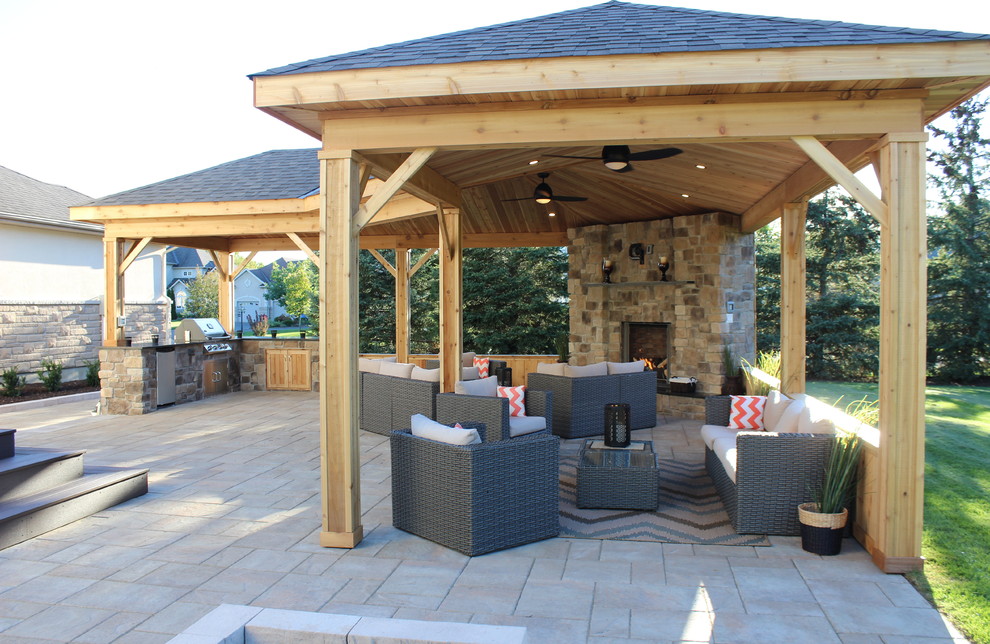 Inspiration for a large rustic backyard concrete paver patio remodel in Ottawa with a gazebo and a fire pit