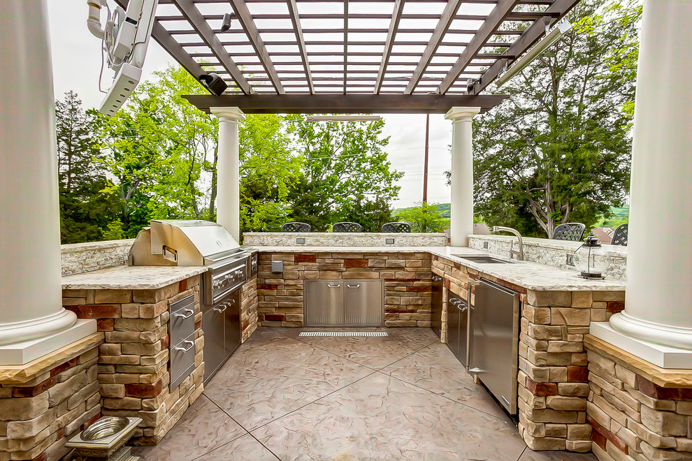 Large classic back patio in Nashville with an outdoor kitchen and a pergola.