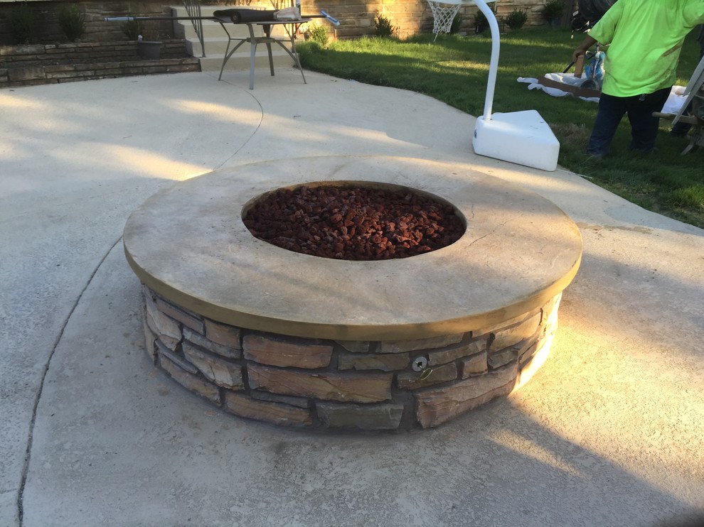 Example of a large classic backyard concrete patio design in Other with a fire pit and no cover