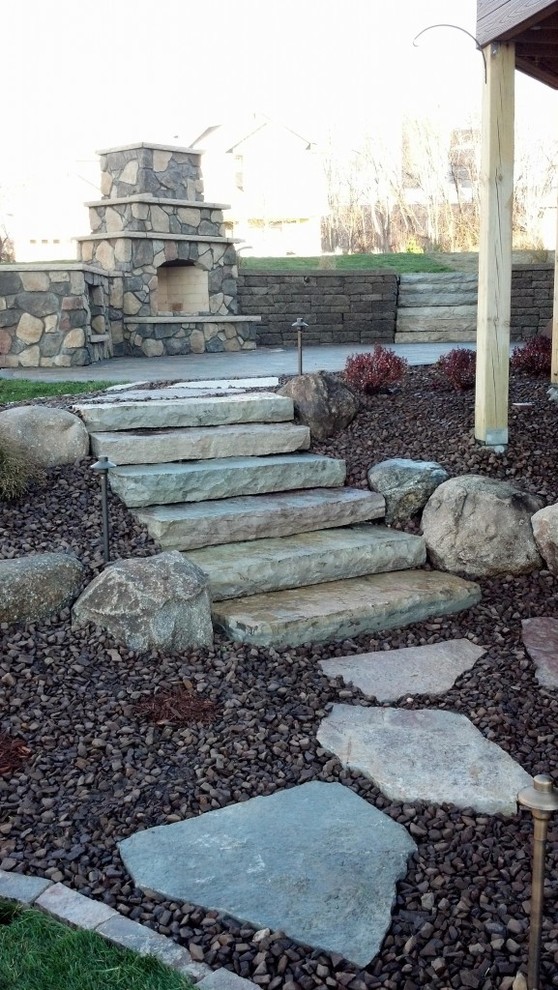 Medium sized classic back garden in Minneapolis with a fire feature and natural stone paving.