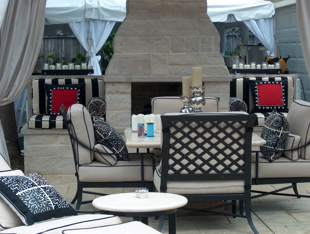 Photo of an eclectic back patio in Dallas with an outdoor kitchen and an awning.