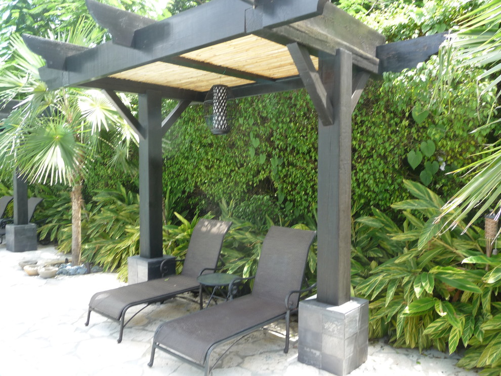 Example of an island style patio design in Miami