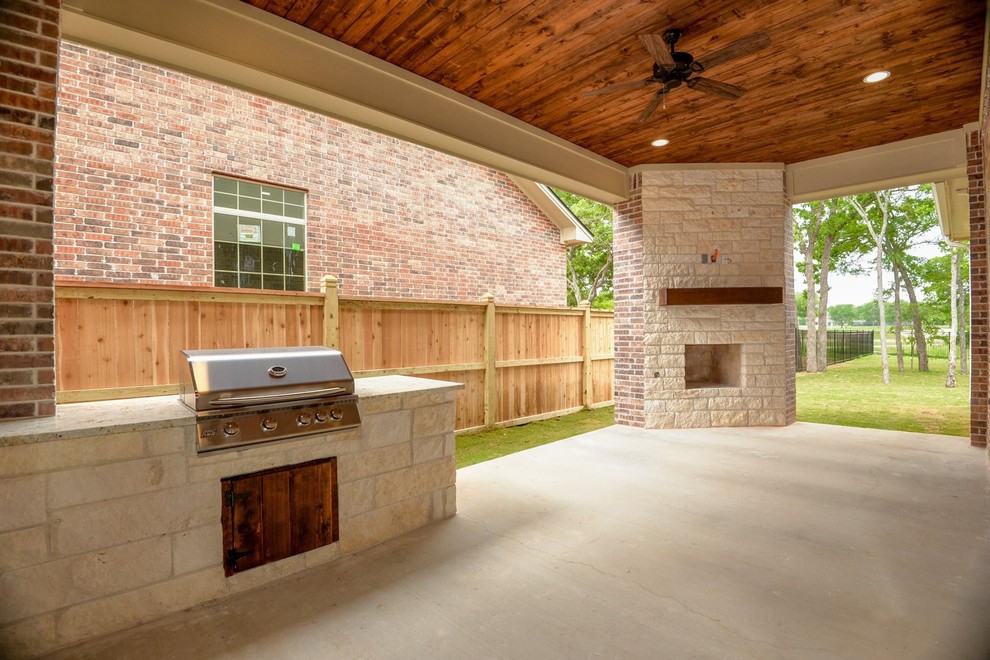 Inspiration for a mid-sized timeless backyard concrete patio kitchen remodel in Other with a roof extension