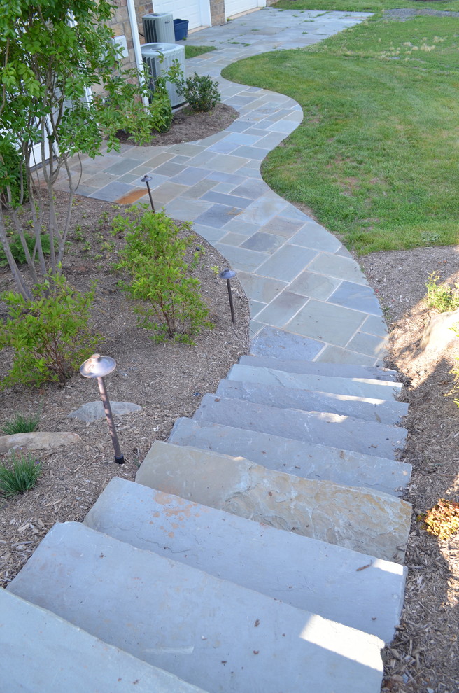 This is an example of a large traditional backyard stone landscaping in DC Metro.