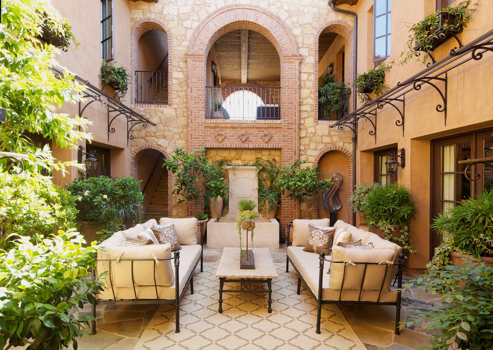 Пример оригинального дизайна: двор на внутреннем дворе в средиземноморском стиле с фонтаном