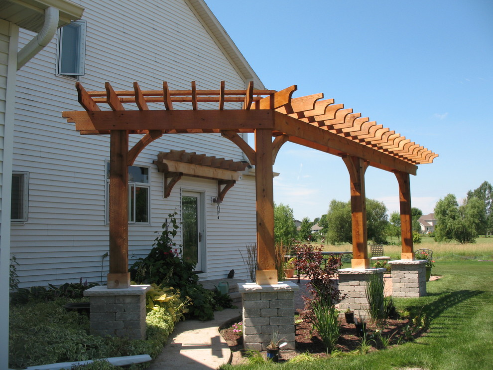 Inspiration for a small classic back patio in Other with concrete slabs and a pergola.