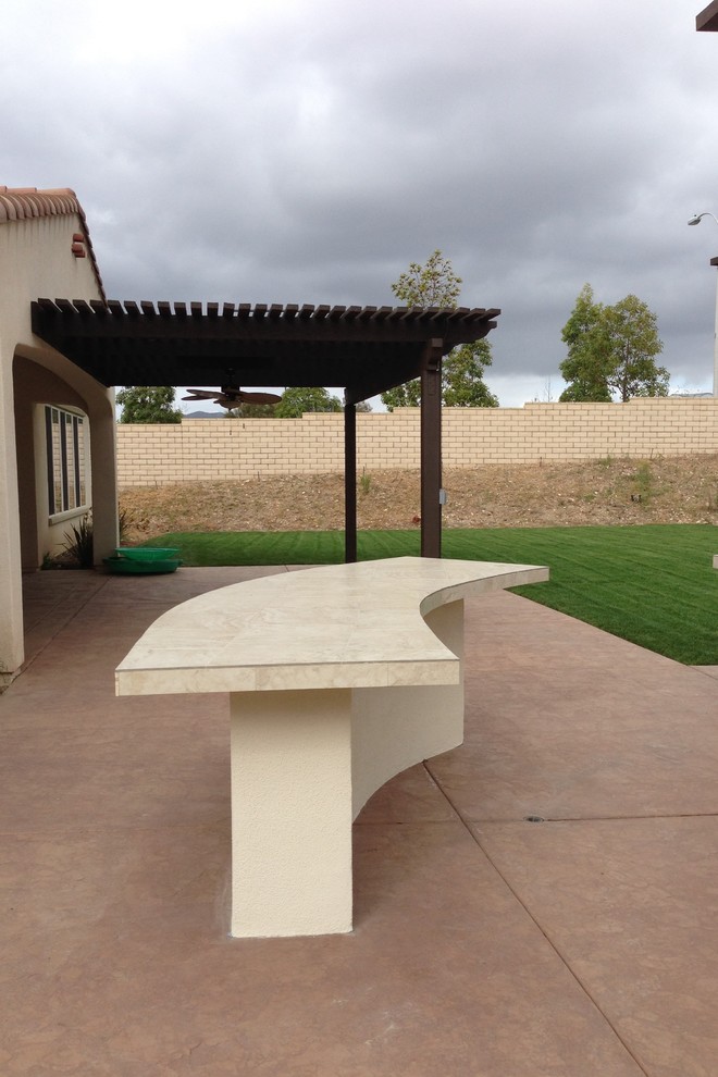 Inspiration for a medium sized traditional back patio in San Diego with an outdoor kitchen, concrete slabs and a pergola.
