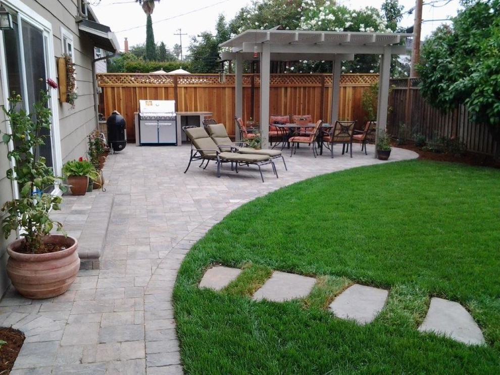 This is an example of a medium sized contemporary back patio in San Francisco with an outdoor kitchen, brick paving and a pergola.