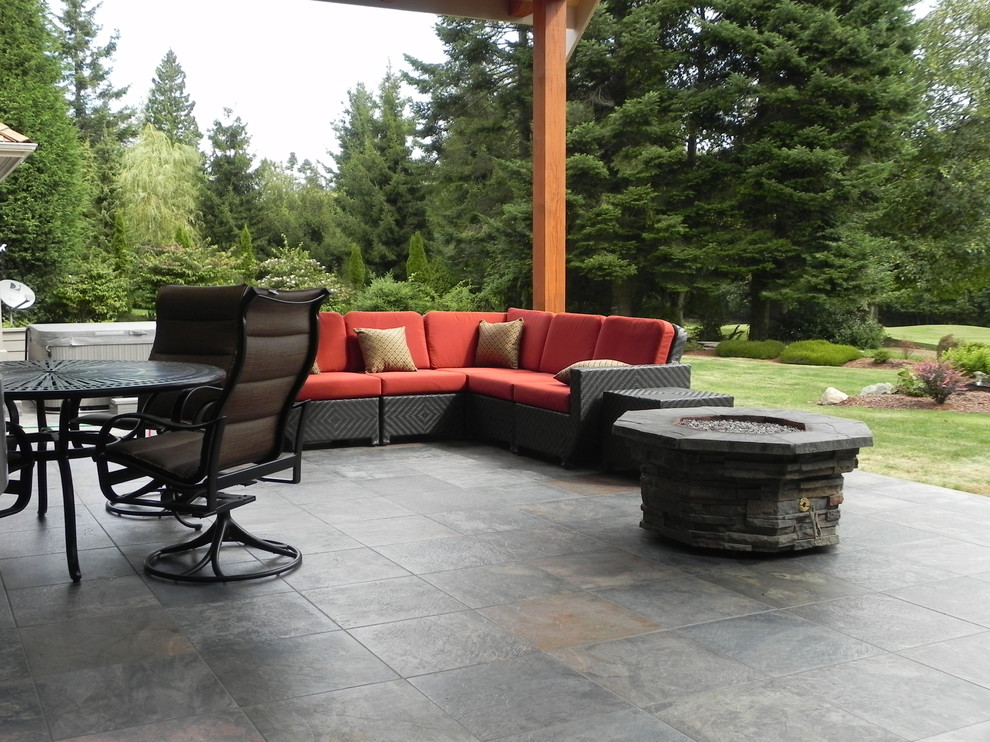 Inspiration for a large craftsman backyard tile patio remodel in Seattle with a fire pit and a roof extension