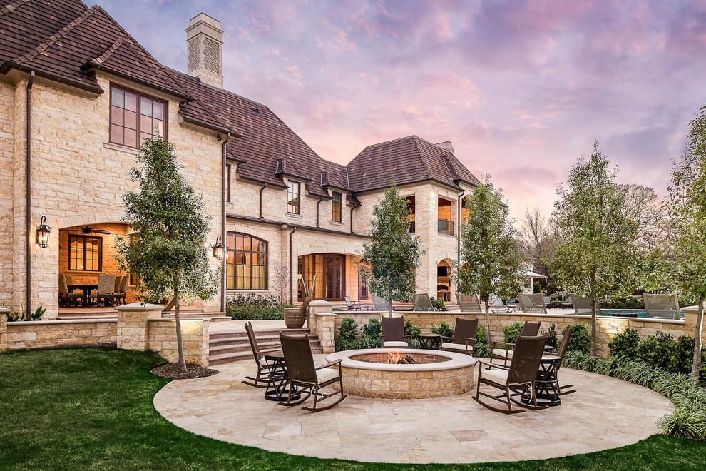 This is an example of a traditional patio in Dallas with a fire feature.