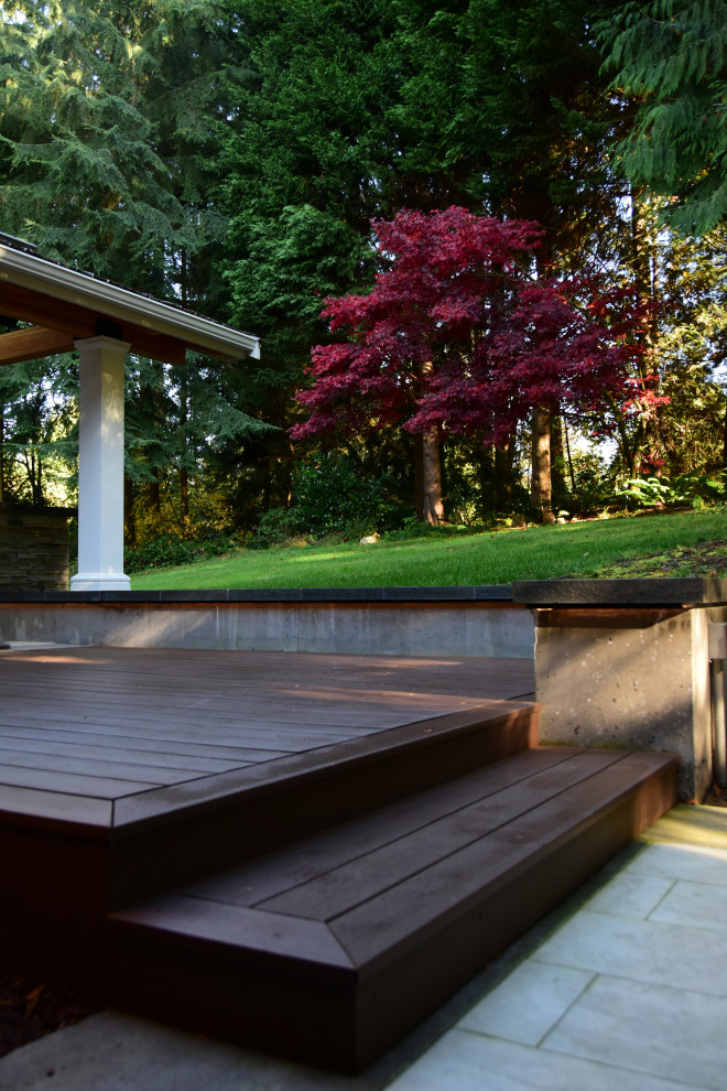 Inspiration for a backyard concrete paver patio remodel in Seattle with a fireplace and a gazebo