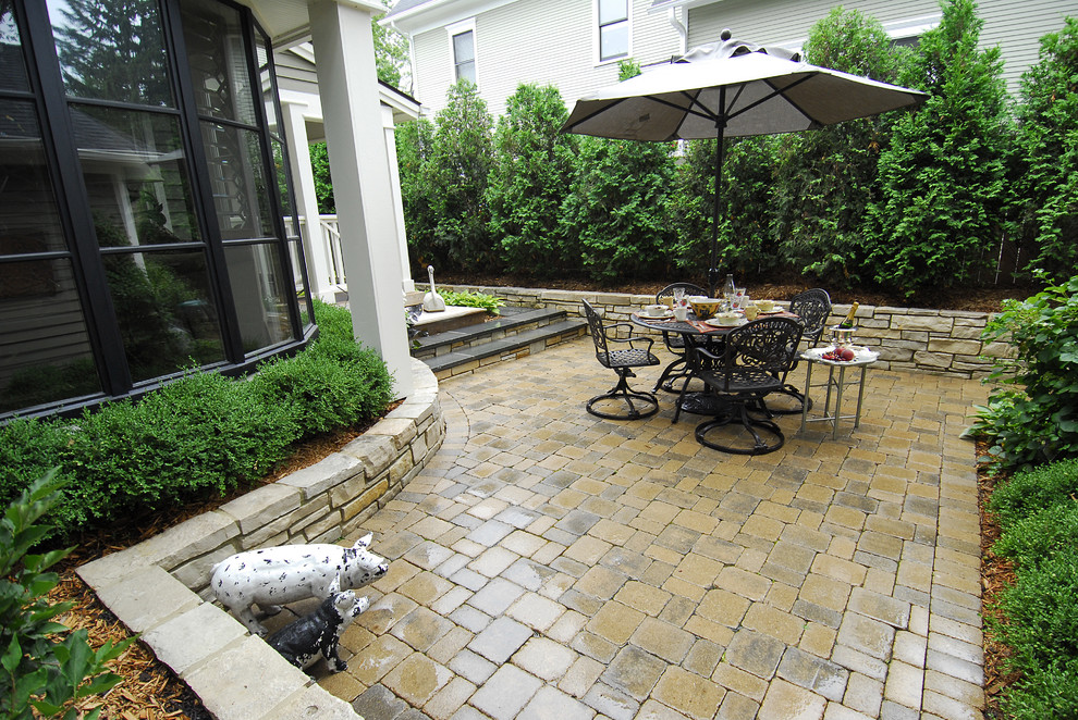 Inspiration for a timeless backyard stone patio remodel in Chicago