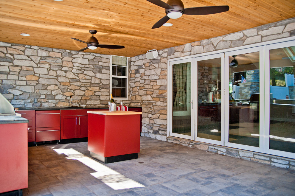 Diseño de patio actual grande en patio trasero y anexo de casas con adoquines de piedra natural y cocina exterior