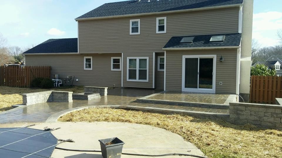 Photo of a large modern back patio in Philadelphia with concrete paving and no cover.
