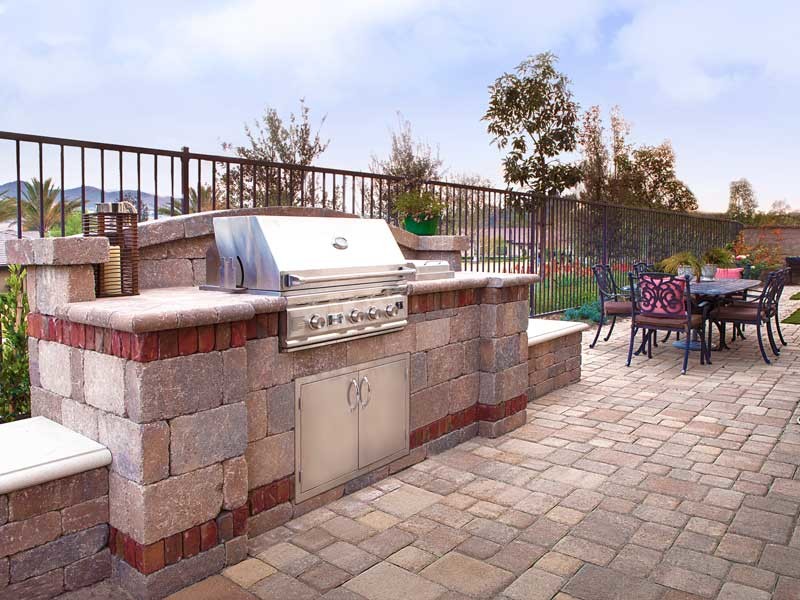 Small elegant backyard stone patio kitchen photo in Orange County with no cover