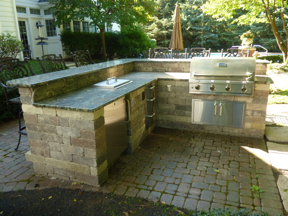 Mid-sized elegant backyard concrete paver patio kitchen photo in Detroit with no cover